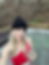 Woman in hot tub wearing red bikini and black knit hat with wine