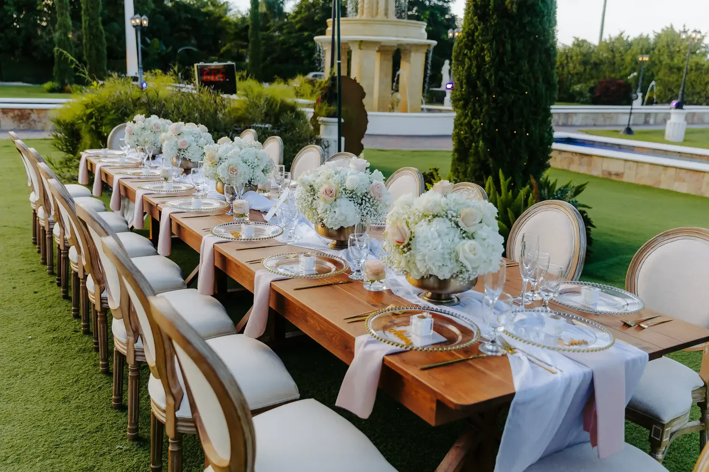 long wood table with white chairs at reception in Villa Toscana Miami