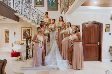 bride in the stairs of the Villa Toscana Miami Mansion with her brides maids