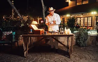 Cigar rolling station at Villa Toscana Miami, a luxury wedding venue in Miami, offering unique entertainment for wedding celebrations. This Tuscan-inspired wedding venue provides all-inclusive wedding packages, ensuring an unforgettable experience at one of the top outdoor wedding venues in Miami.
