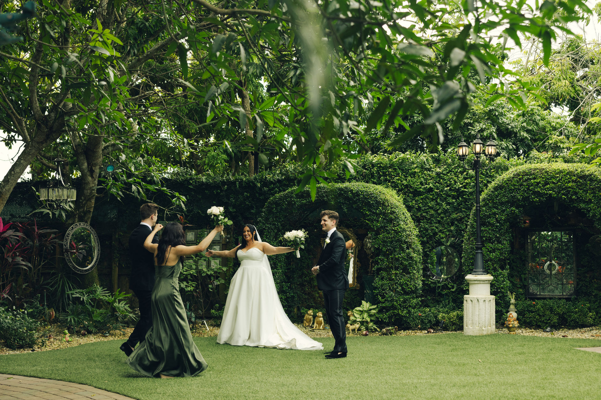 bride with groomsmen at secrett garden in Villa Toscana Miami