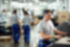 mid-adult-worker-operating-cnc-machine-while-working-industrial-facility.jpg