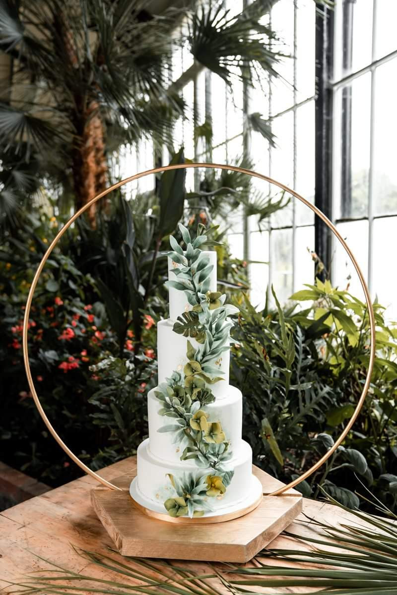 white wedding cake with green foliage