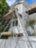 Close-up of scaffolding on white wooden house