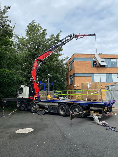 Large lorry lifting equipment into an office building