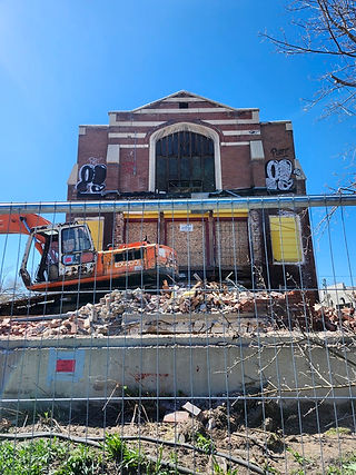 Front view of the partially demolished 5th Ward Meeting House in Salt Lake City with rubble front.