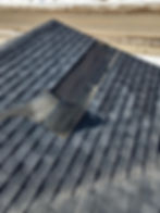 Wind damage on a roof made with asphalt shingles