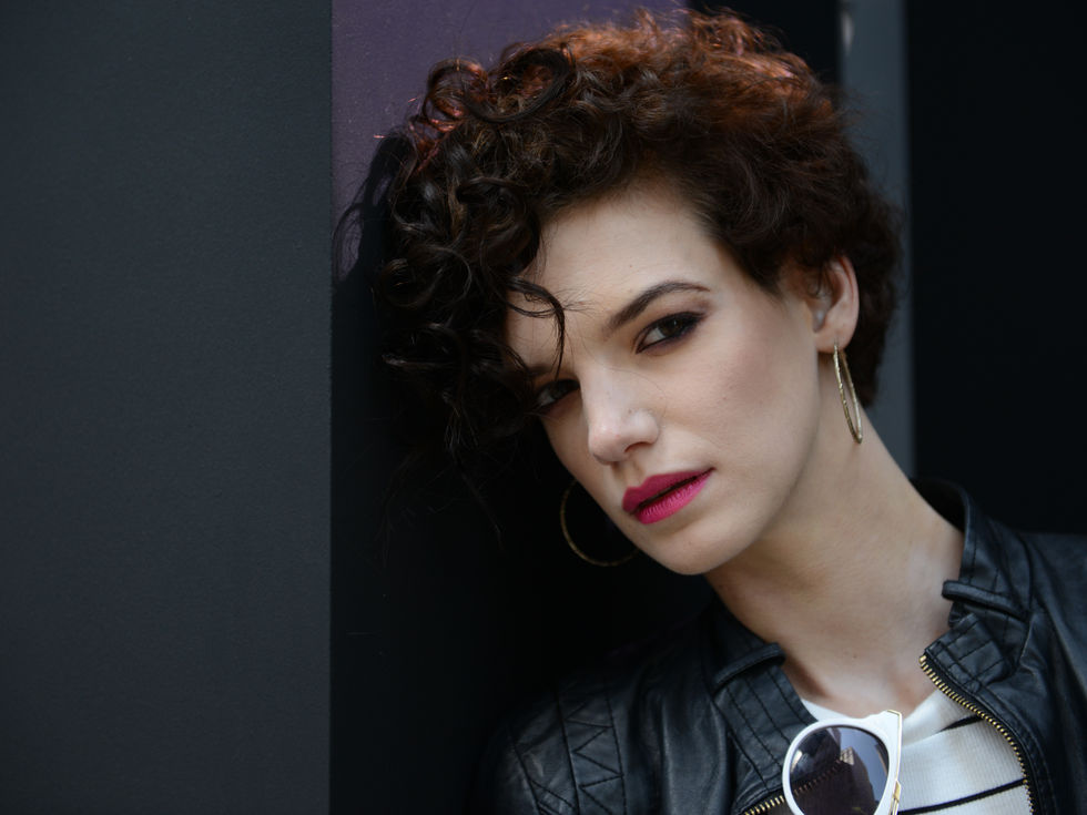 Professional model with soft glam makeup, glowing skin, and defined features during photoshoot.