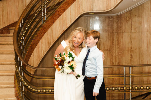 Natural bridal makeup featuring radiant skin, soft taupe eyeshadow, delicate lashes, and nude-pink lips for a timeless weddin