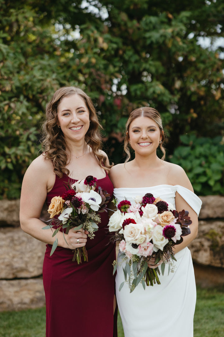 Fall outdoor wedding moment featuring bridal and bridesmaid glam makeup