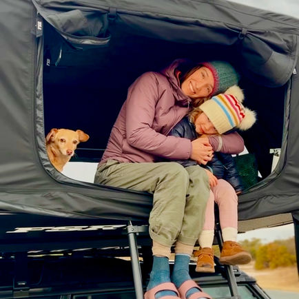 Woman, Child, and Dog in Rooftop Tent Camping