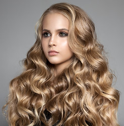Portrait Of A Beautiful Young Blond Woman With Long Wavy Hair.jpg