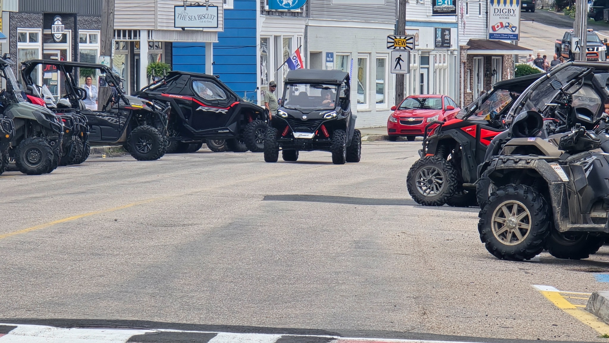 ATVs and side-by-sides gathered on a street in downtown Digby during ATV Invasion