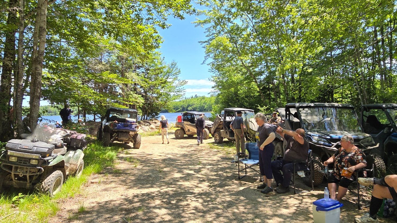 Club riders enjoying a scenic lakeside stop