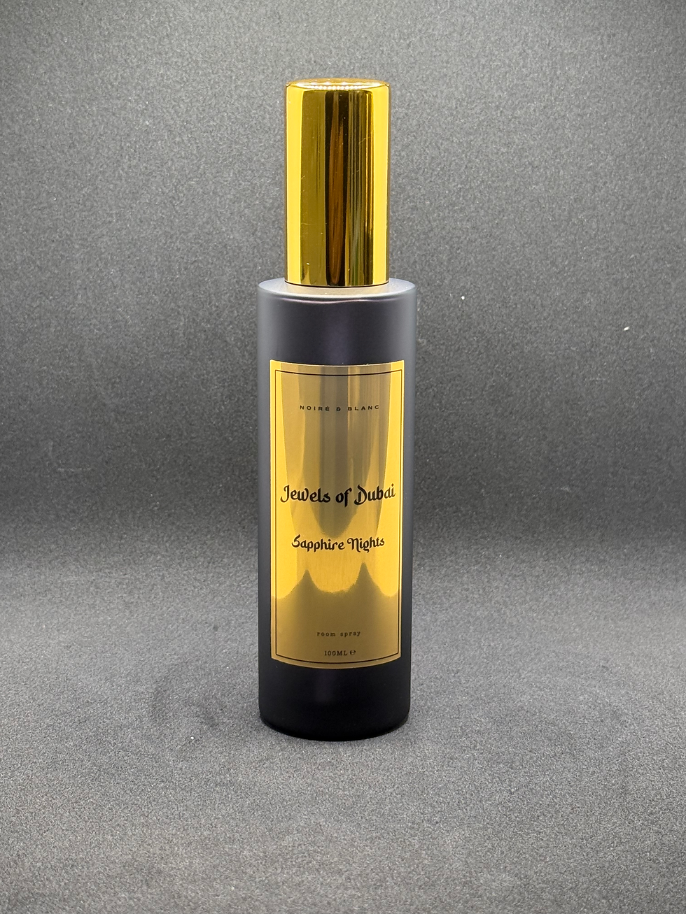 A room spray in black bottle with gold lid and label