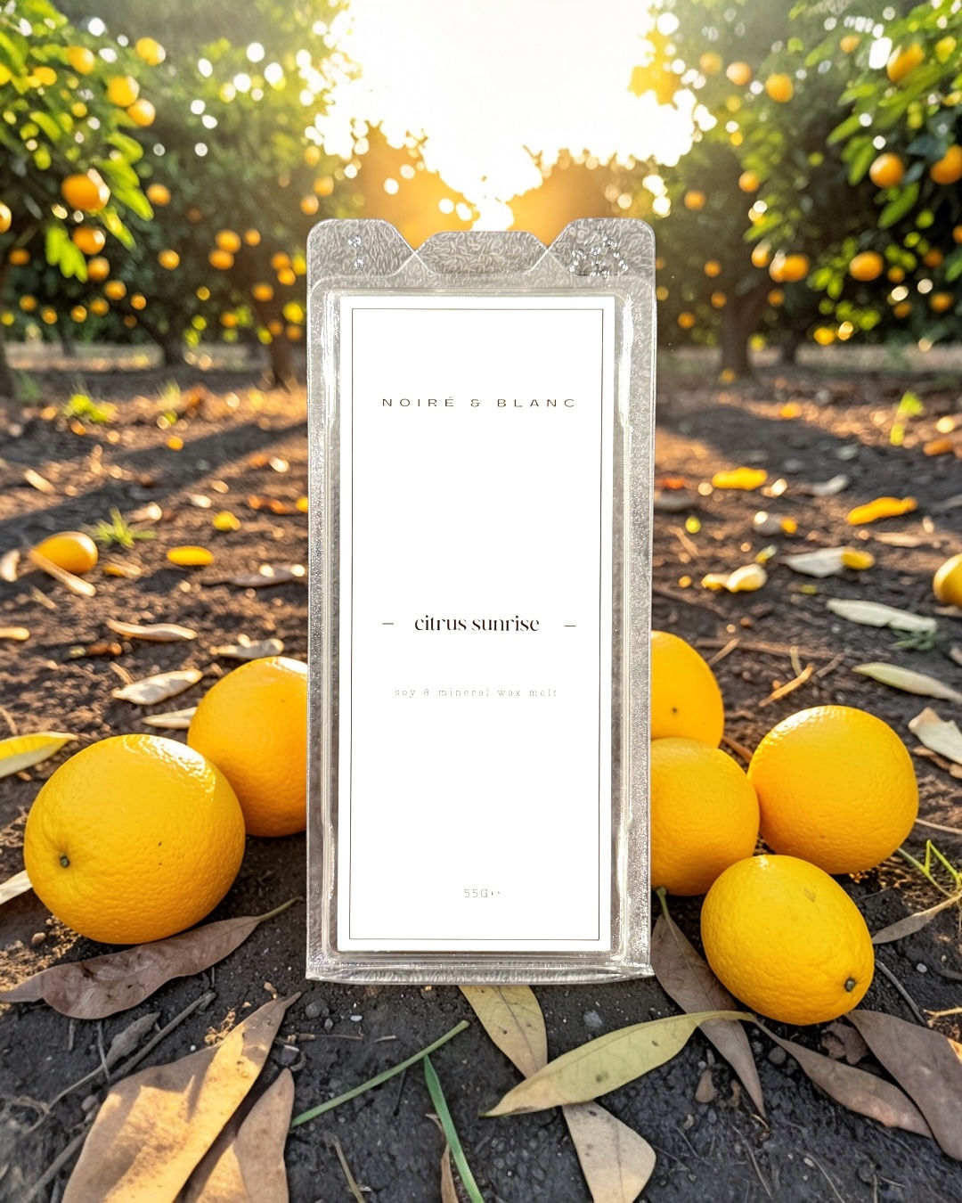 A wax melt snap bar with oranges in front of the sunrise