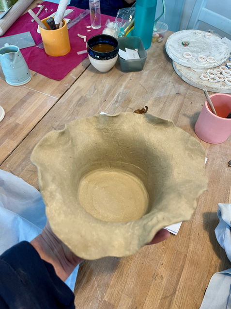 Organic hand-shaped bowl in progress in the studio