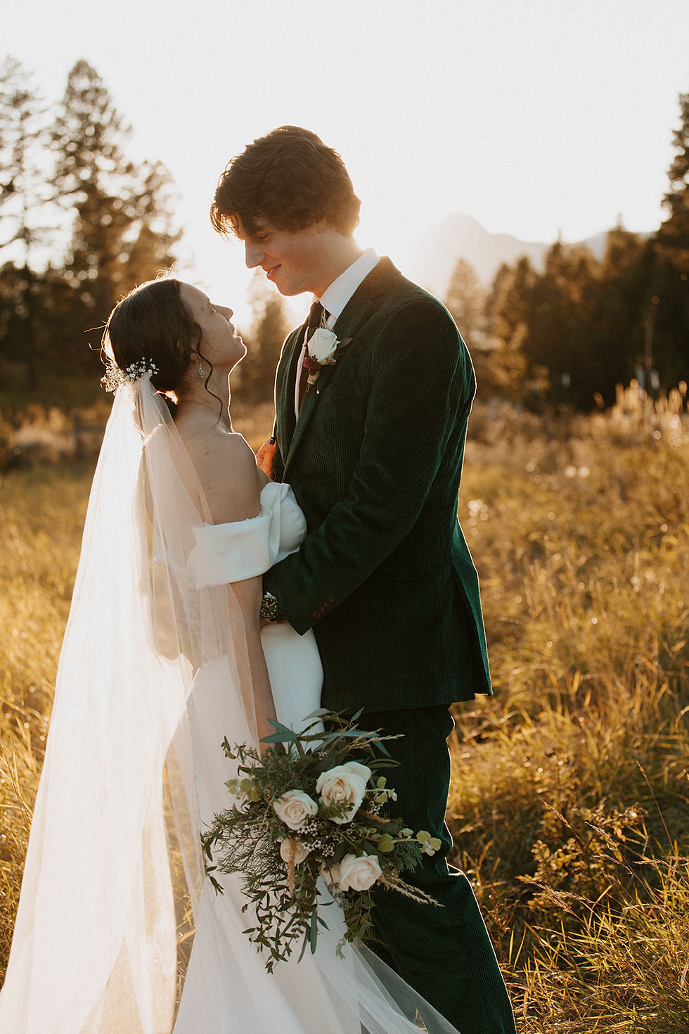 Newlyweds embrace in front of Ross Peak in Bozeman Montana