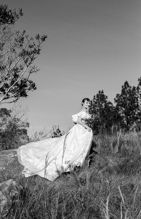 Bride running across a field