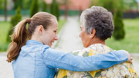 Compassionate support: A caring woman's arm rests reassuringly on the shoulder of an elderly lady, symbolizing personalized assistance and connection in aged care.