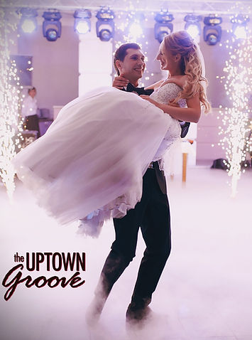 Groom carrying bride, enjoying live wedding music in Buffalo