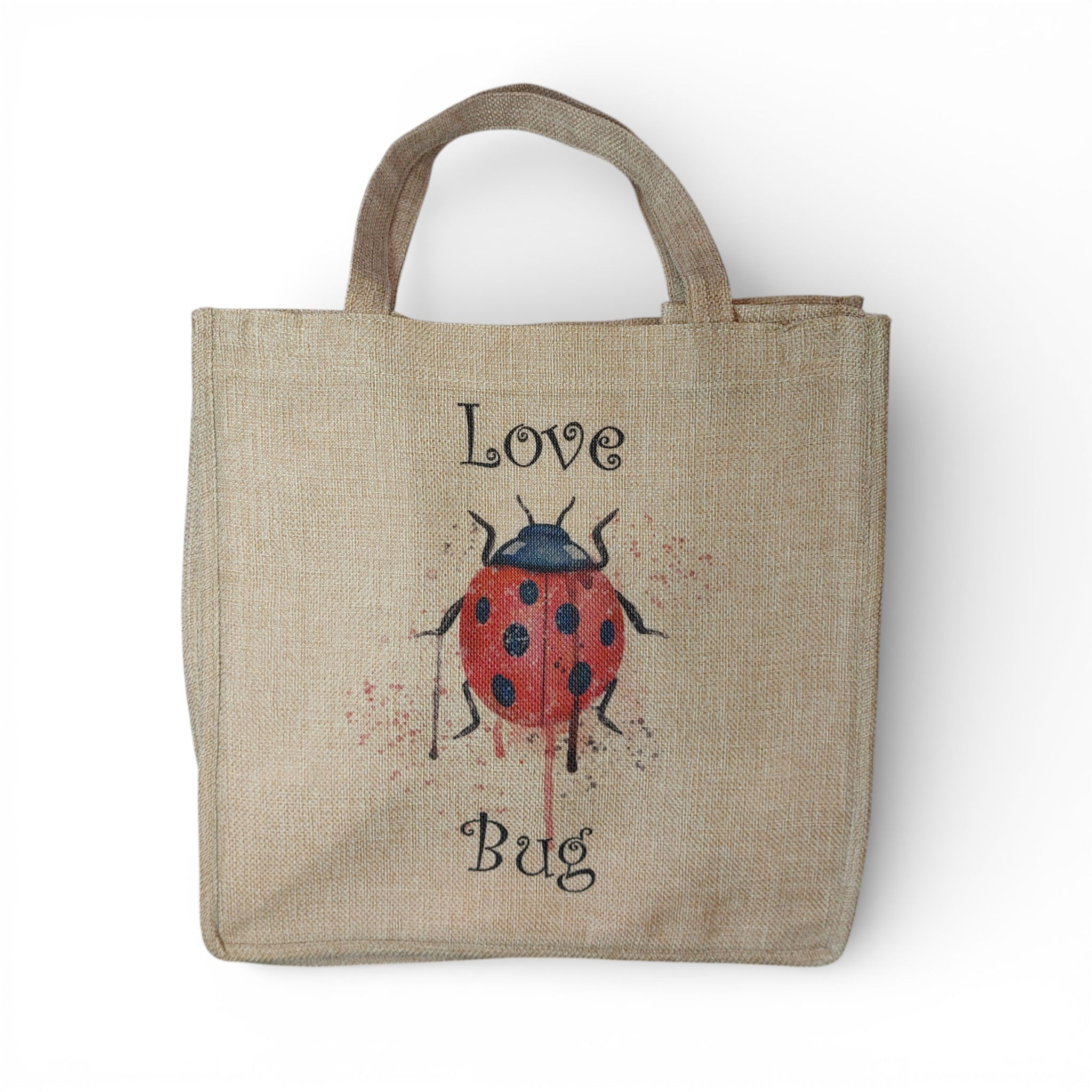 Watercolour Ladybird with paint splatter and drips in the middle of "Love Bug" slogan in black script on a burlap bag