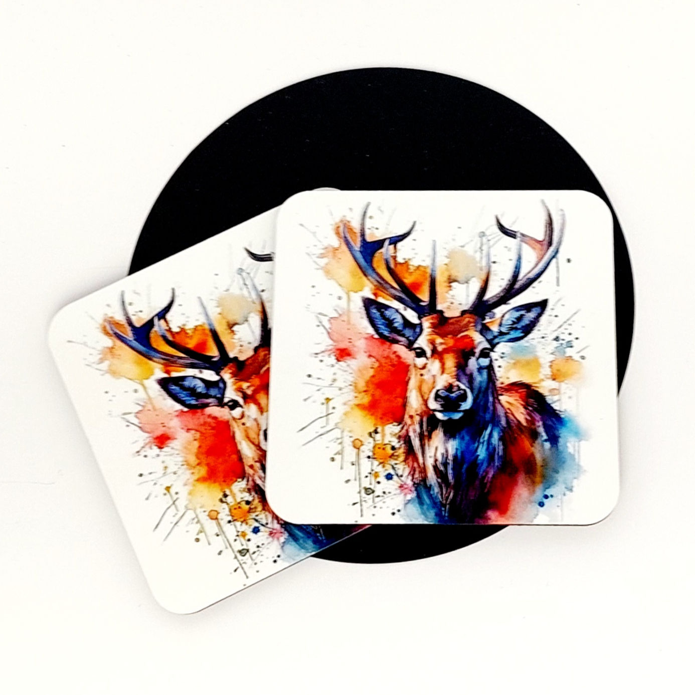 Majestic Stag Head in watercolour with hues of orange, brown & blues with smokey paint splashes and drips on a white Coaster