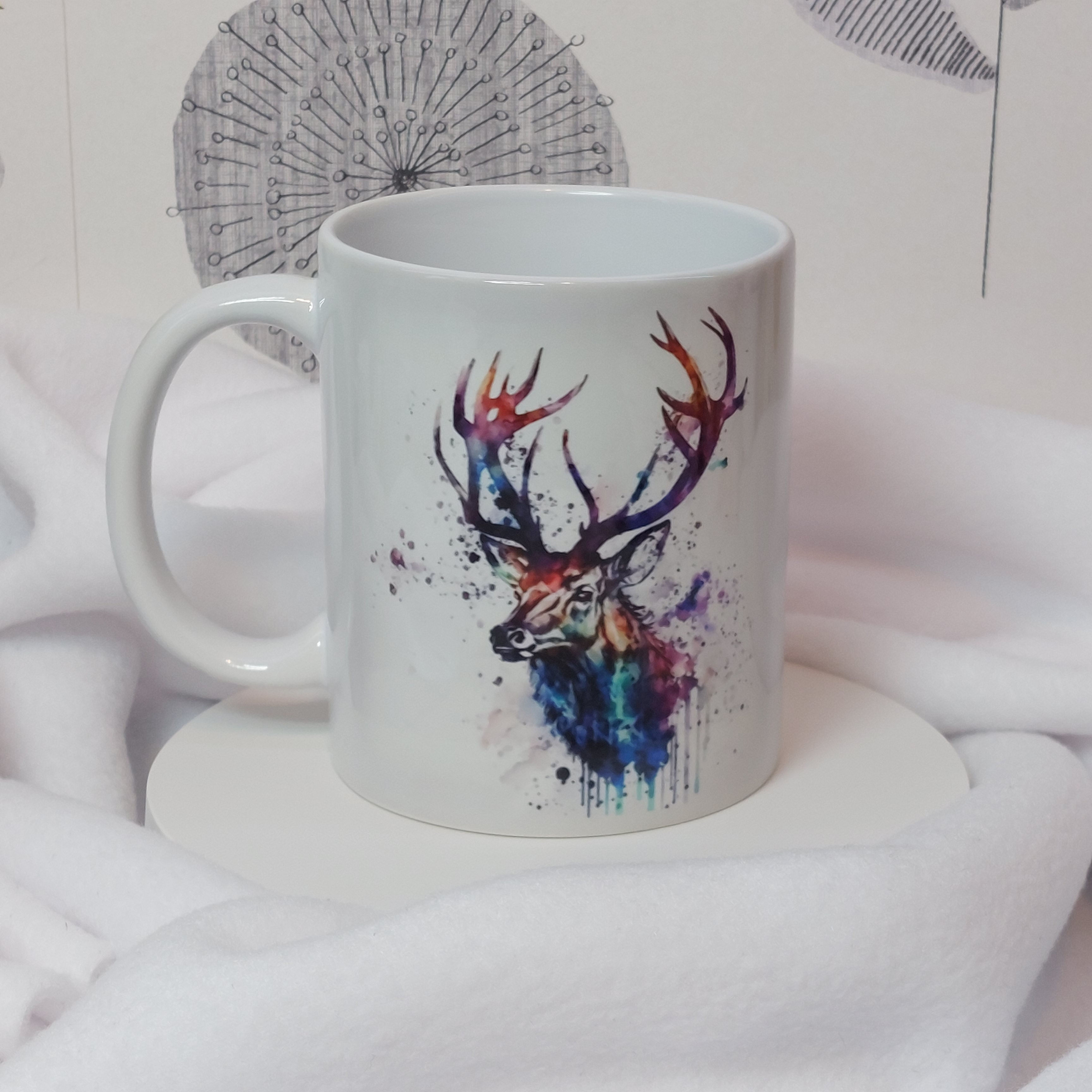 Deer Head in watercolour with bright hues of purple, teal and blues with smokey paint splashes and drips on a white mug