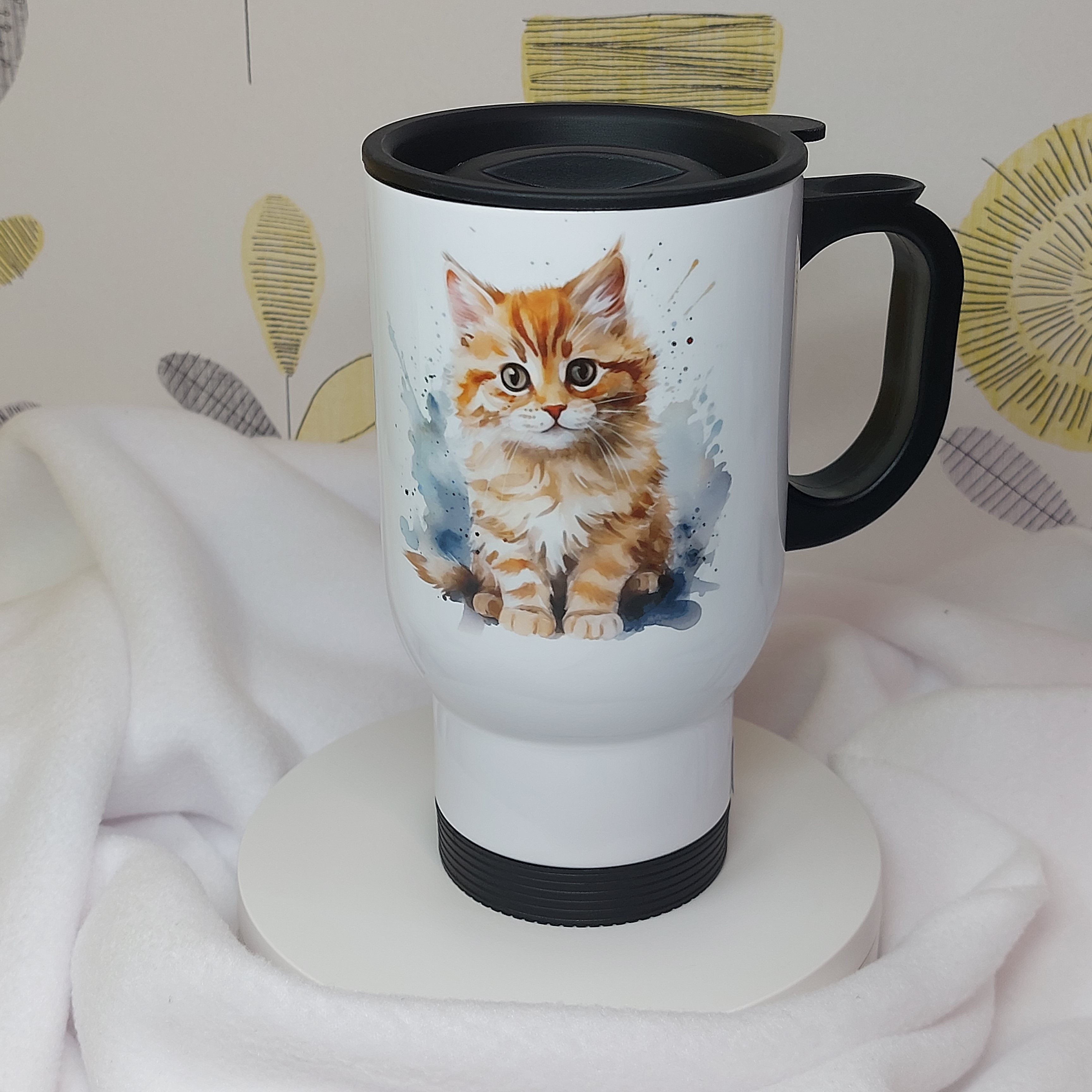 White Stainless Steel Travel Mug, Ginger Kitten Watercolour image, black plastic handle and press on lid.
