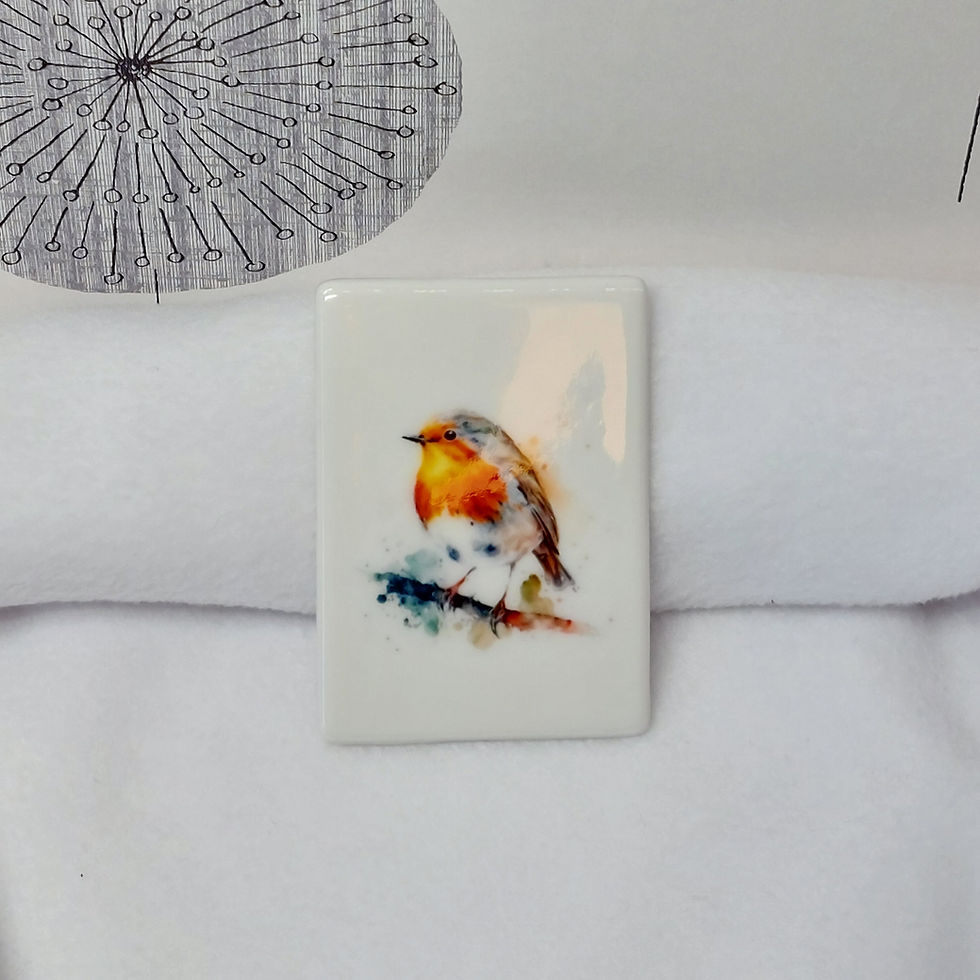 Watercolour image of a robin with a redbreast, stood on a branch with puffs and splashes of paint on a ceramic magnet