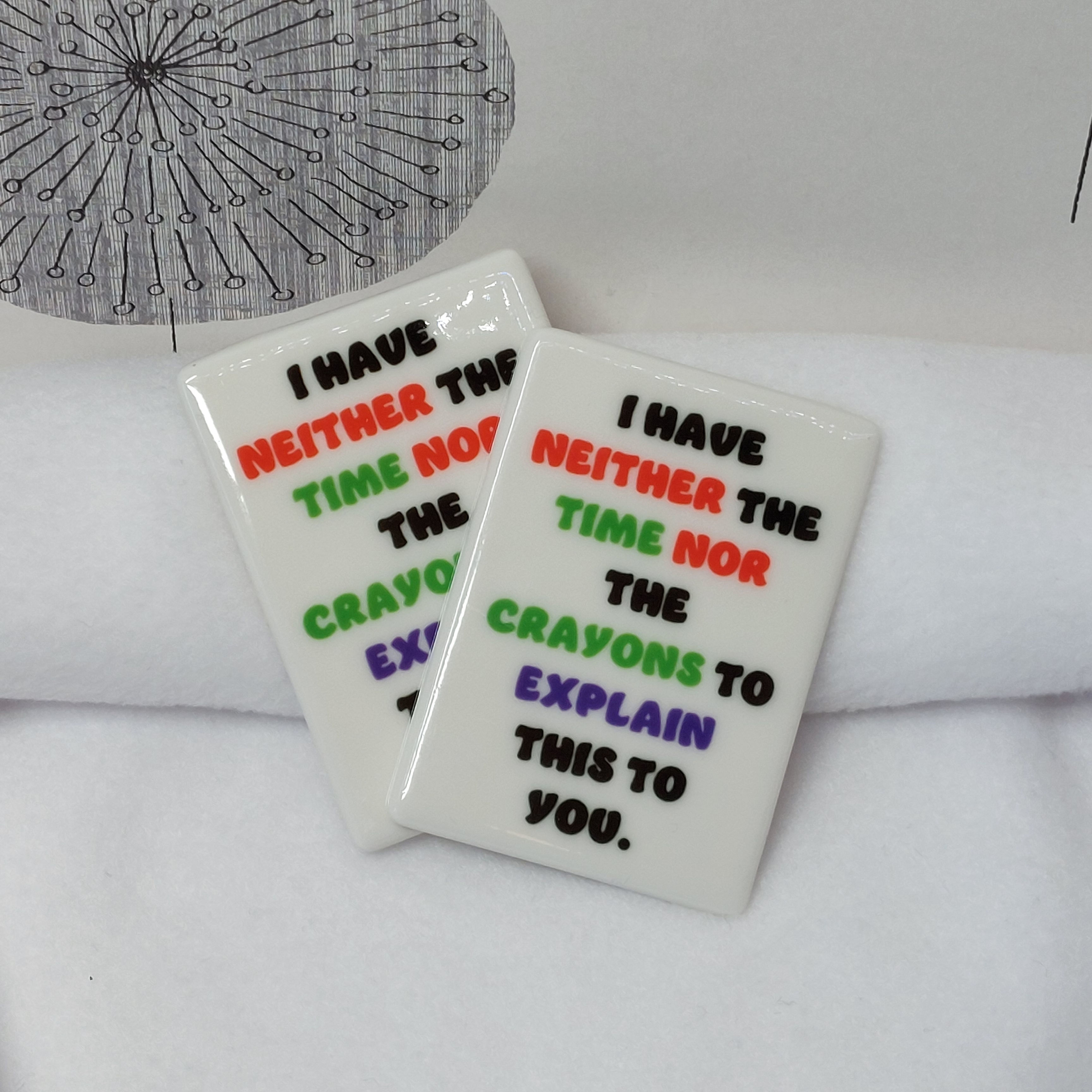 "I Have Neither The Time Nor The Crayons To Explain This To You" in colourful text on a rectangular ceramic magnet