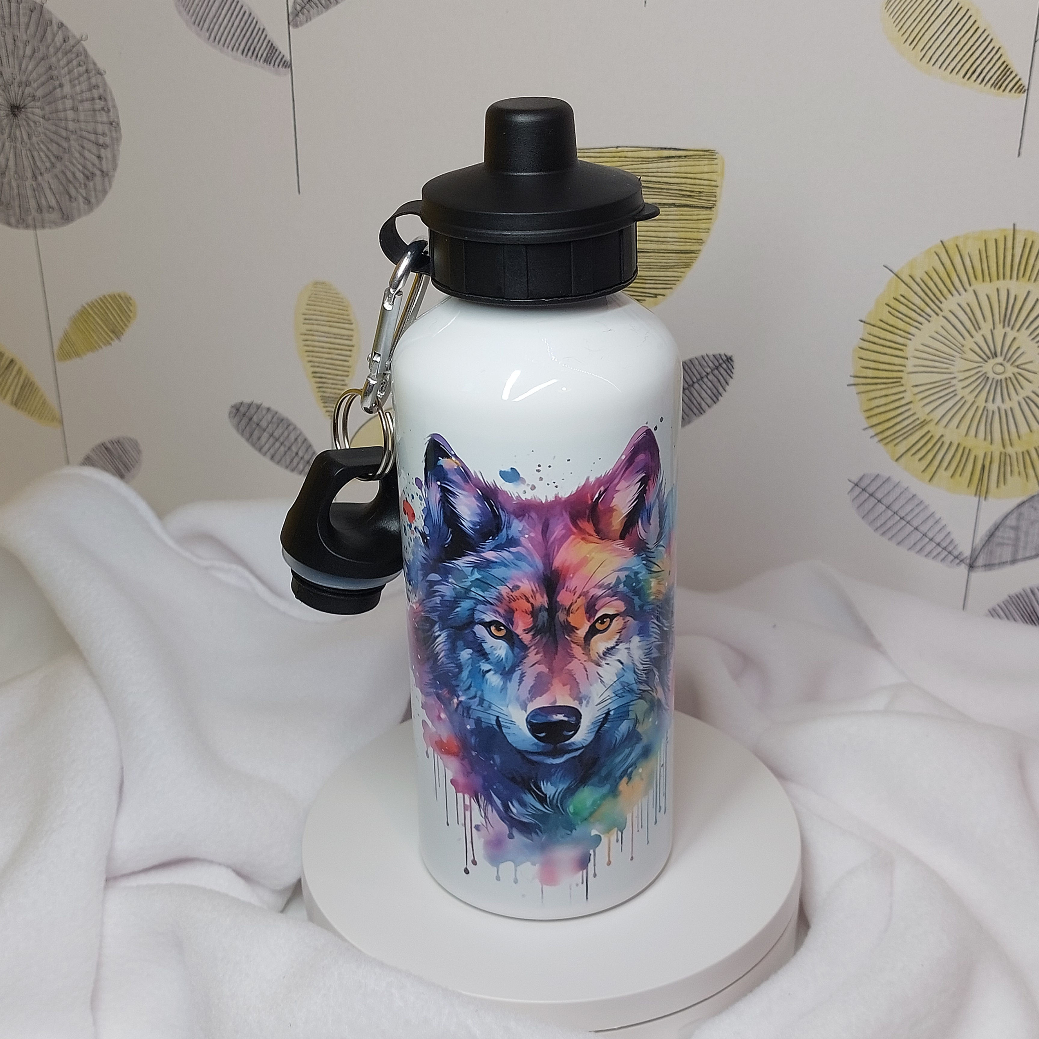 White aluminium water bottle with rainbow watercolour Wolf head, paint splashes and drips, with a screw top and sports lid.