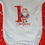 Thumbnail: White Baby Vest with "1st Christmas" motif in red font and Santa holding presents