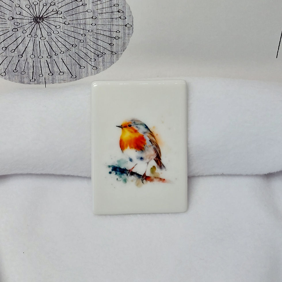 Watercolour image of a robin with a redbreast, stood on a branch with puffs and splashes of paint on a ceramic magnet