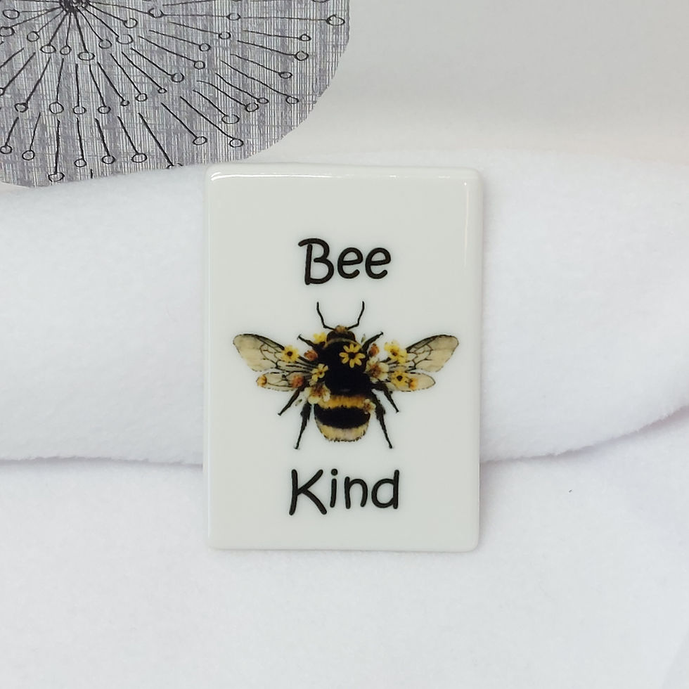 watercolour image of a Bumble Bee with flowers and the words "Bee Kind" in a soft black font on a rectangular ceramic magnet