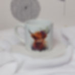 watercolour young highland cow with flowers on its horn on a 6oz white ceramic mug