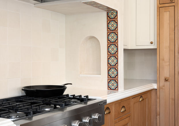 Coastal Kitchen with wood and white cabinetry and plaster hood