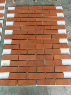 Array of orange bricks placed neatly on the floor for construction.