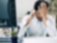 Person talking on the phone with hand on their face