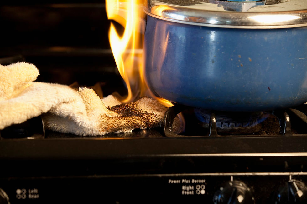 A pot on a stove with flames rising from it