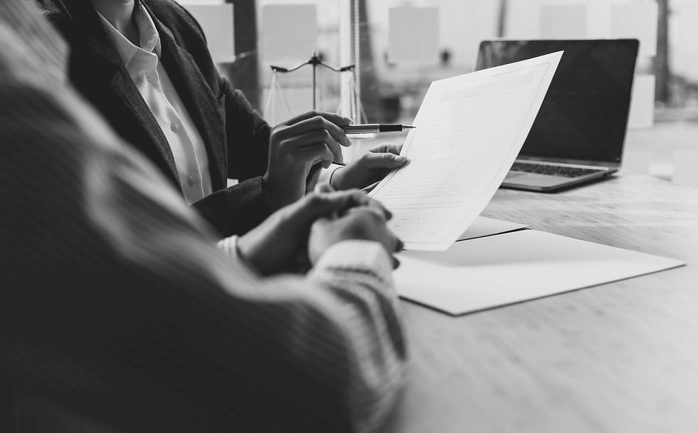 A couple discussing legal papers in an office