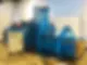 Large industrial blue baler machine in a warehouse