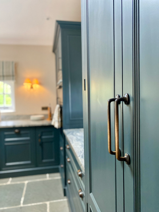 Light-filled kitchen and dining space in a luxury home extension, featuring classic finishes and furnishings that complement the historic character of the residence.