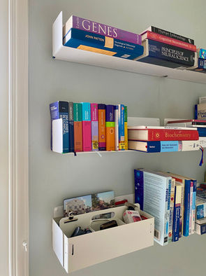 Refreshed study featuring original sanded floorboards, a deep blue painted cupboard, and decorative accessories and Bookshelves.