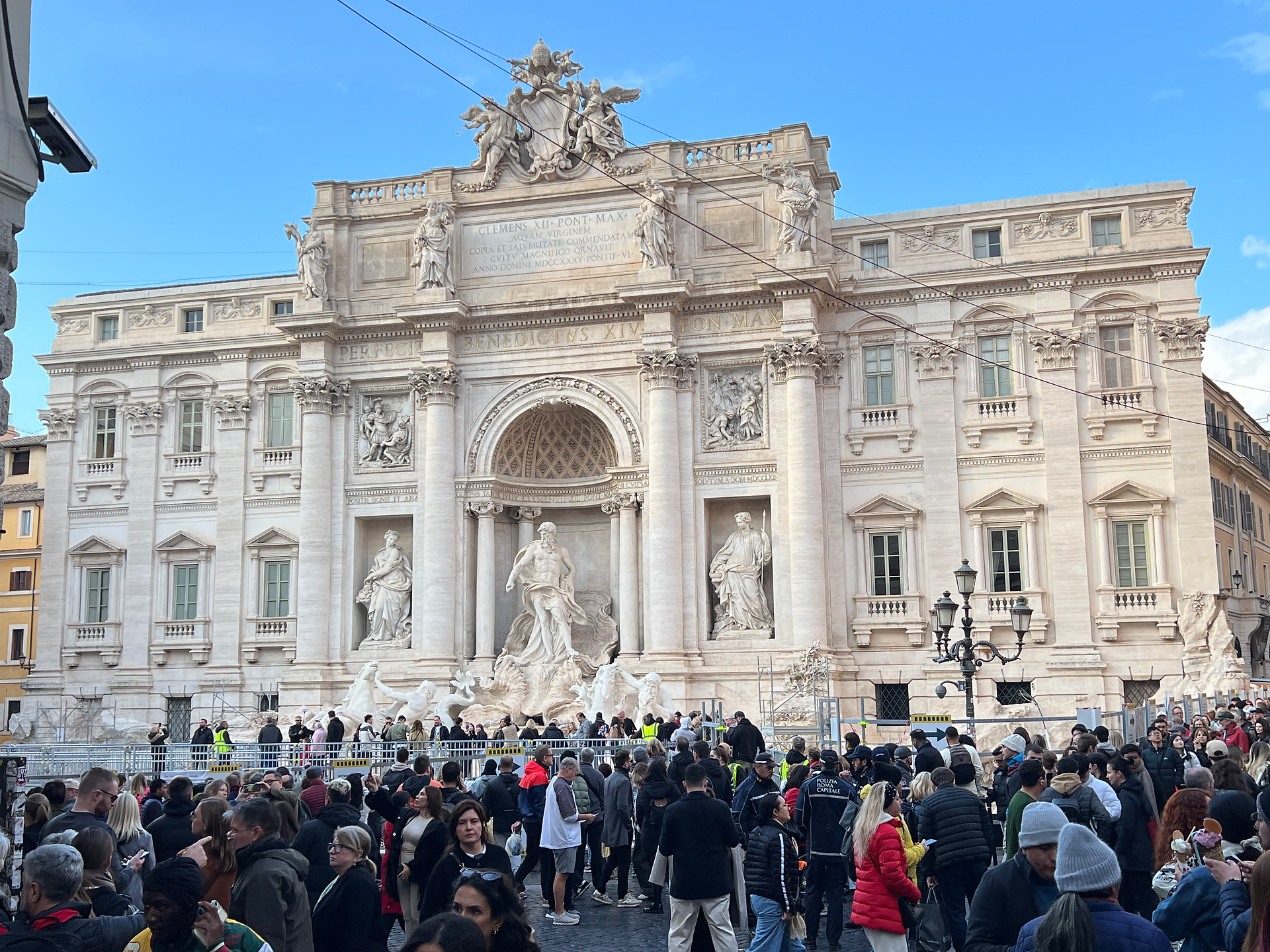 A picture of the Trevi fountain with a crowd onlooking