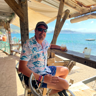 man in beach bar with drink