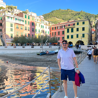 man in front of water in vernazza, italy