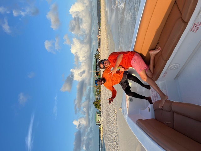 two men on boat giving peace signs