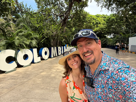 A couple standing in front of a lettered sign that spells out COLOMBIA at the Cartagena cruise port