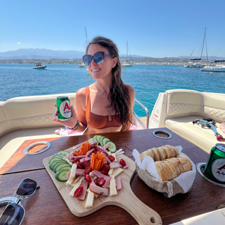 woman in front of charcuterie board in the agean sea